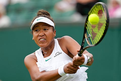 Naomi Osaka plays a backhand return to Diane Parry